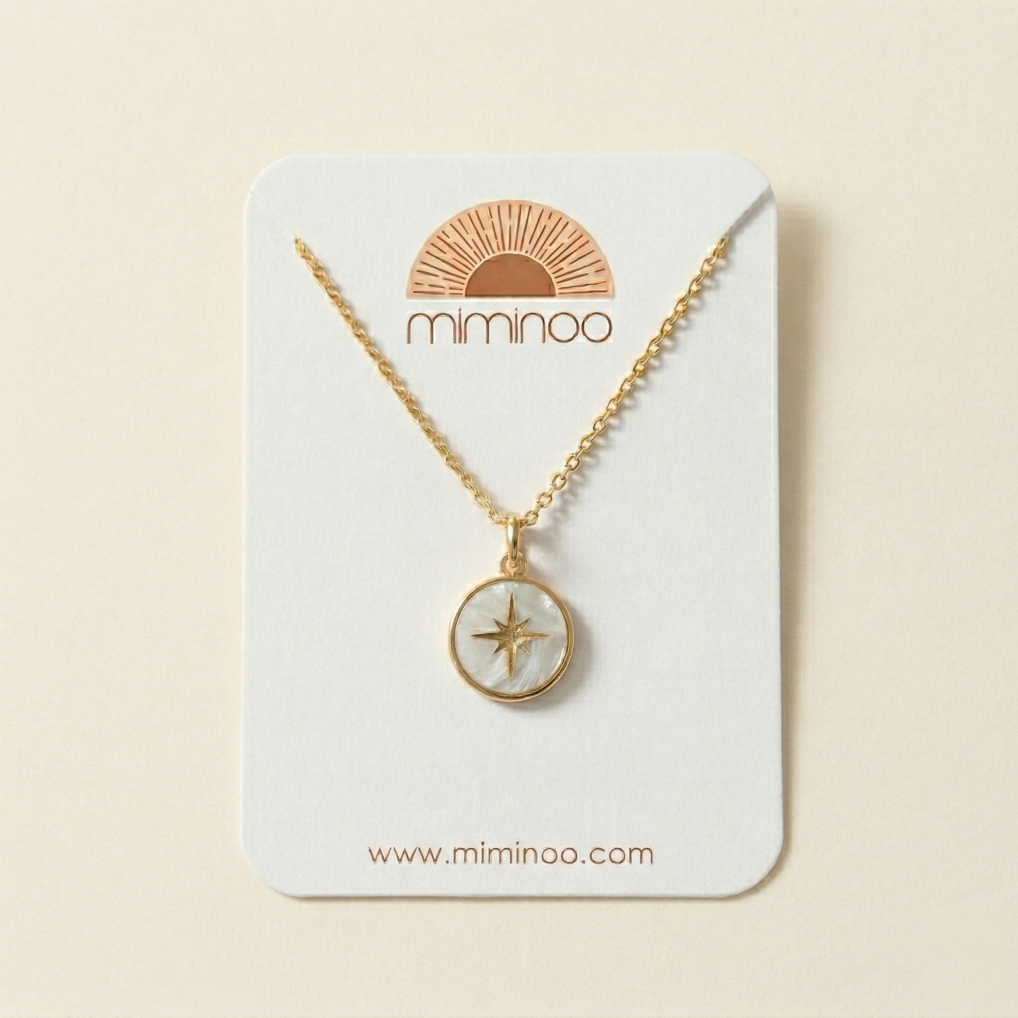 Gold necklace with star pendant on a Miminoo branded card