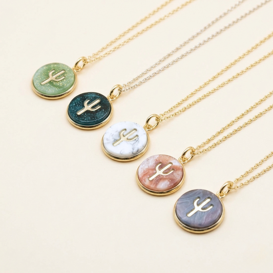 Set of necklaces with cactus pendant on a light background