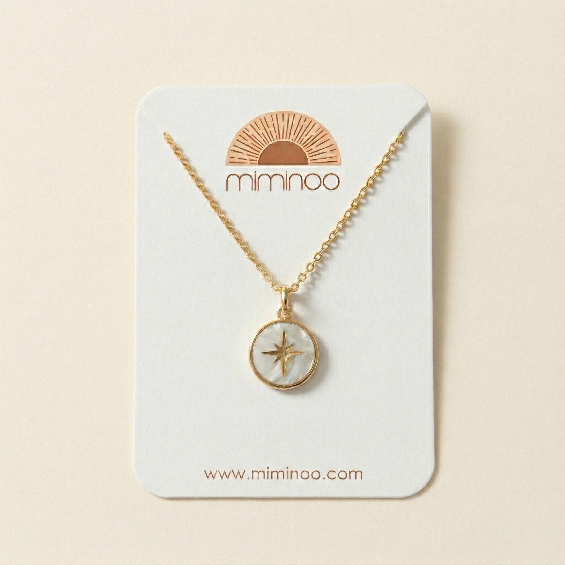 Gold necklace with star pendant on a Miminoo branded card