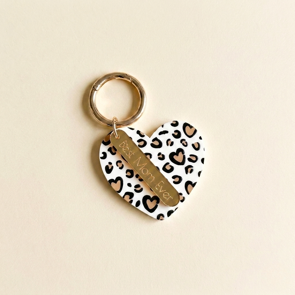 Heart-shaped keychain with leopard print pattern and 'Best Mom Ever' text on a beige background