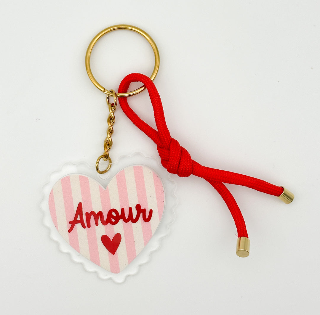 Amour heart keychain and bag charm with pink striped heart, red cord detail, and gold-tone keyring by Miminoo Jewelry