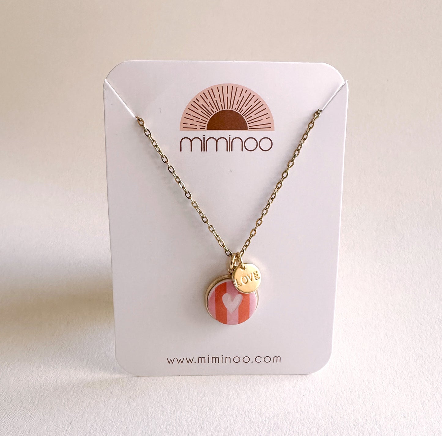 Miminoo gold necklace: striped heart charm, "LOVE" pendant.